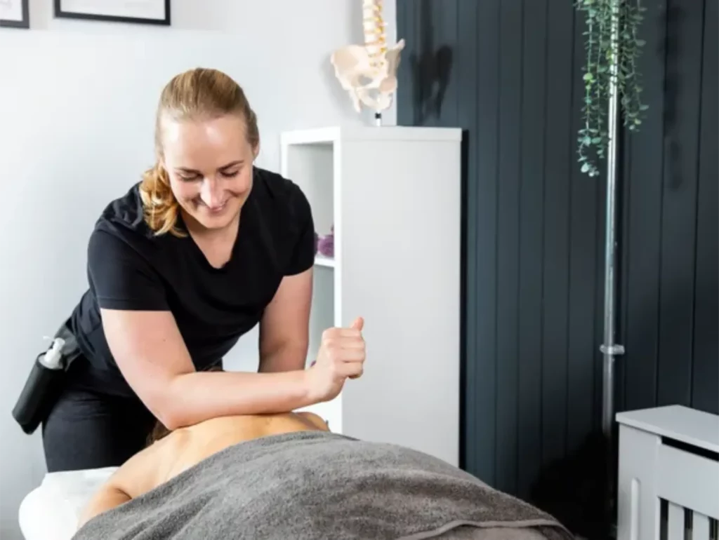 massage therapist performing deep tissue massage